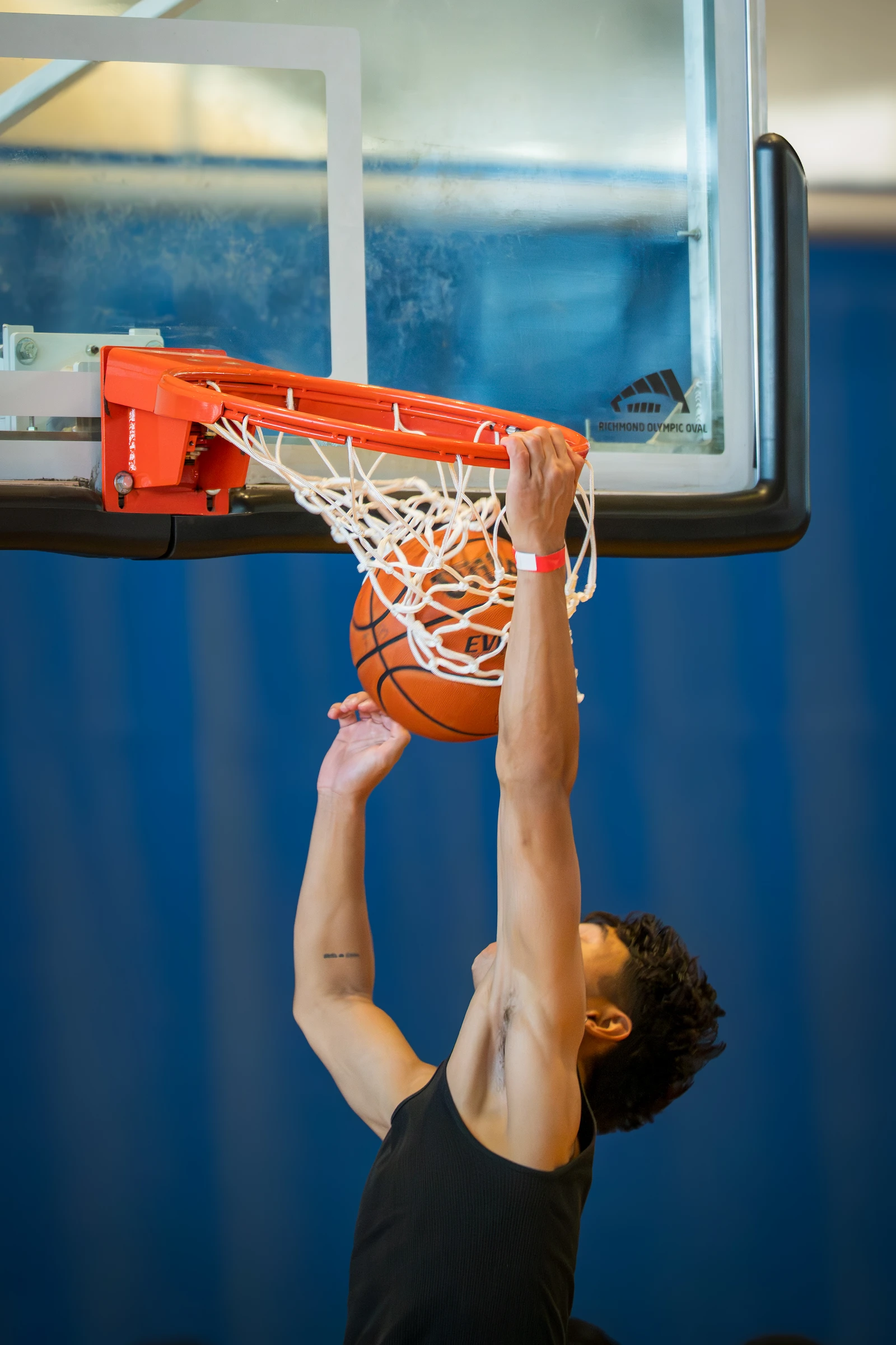 Player dunking and hanging on the rim at 3PB tournament