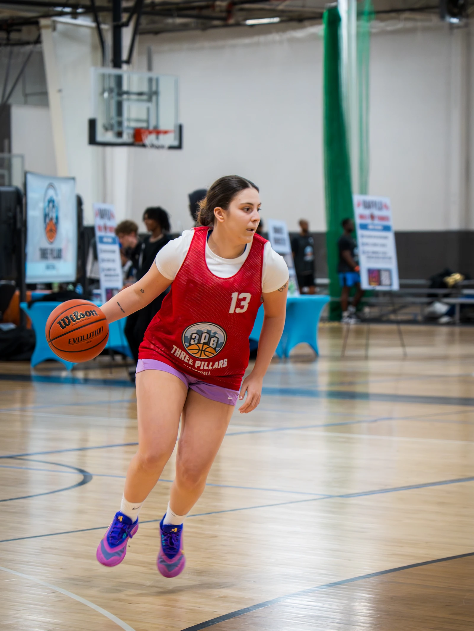 Female player driving to the basket at 3PB tournament