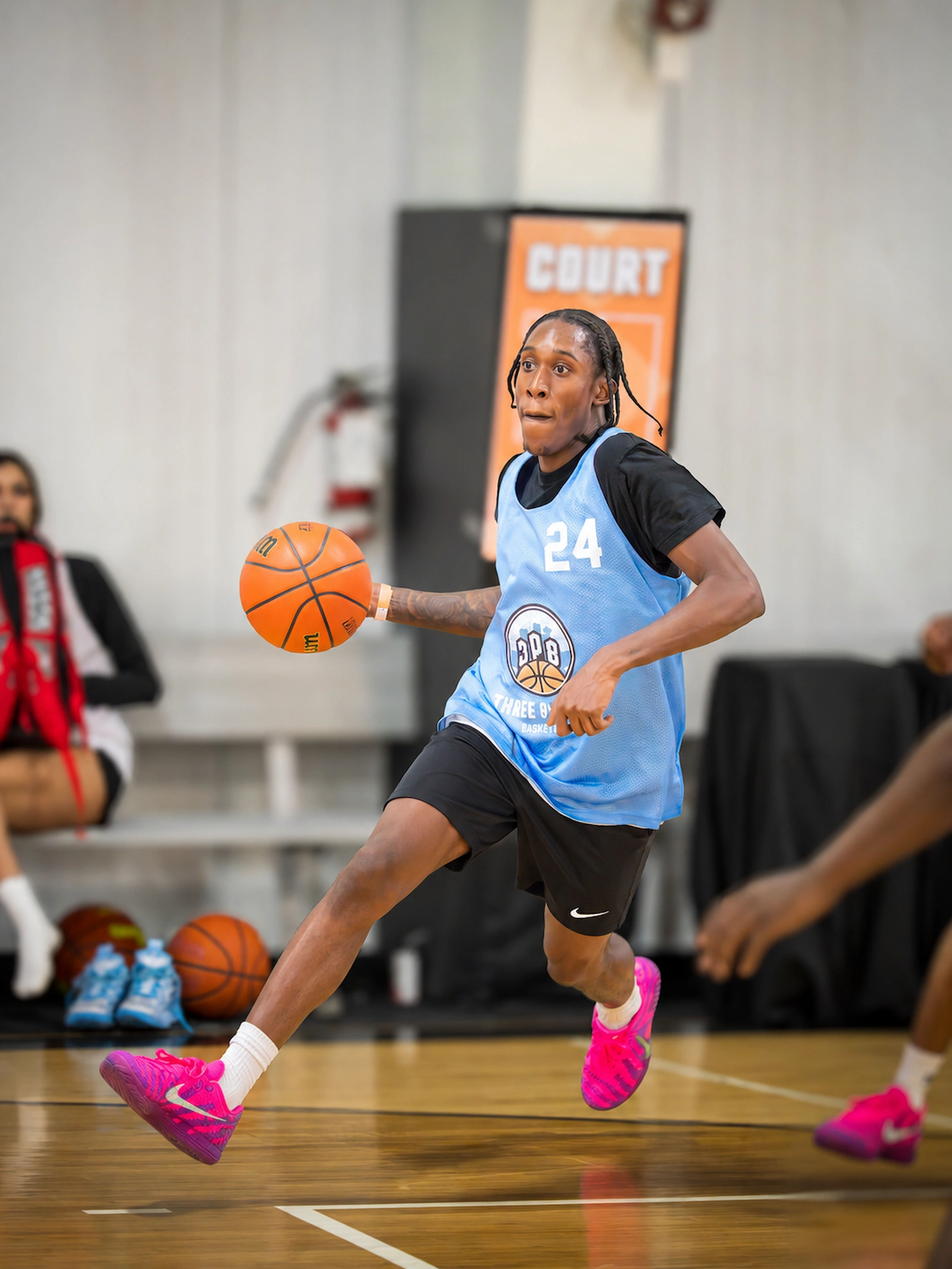 Player completing an acrobatic reverse layup at 3PB tournament